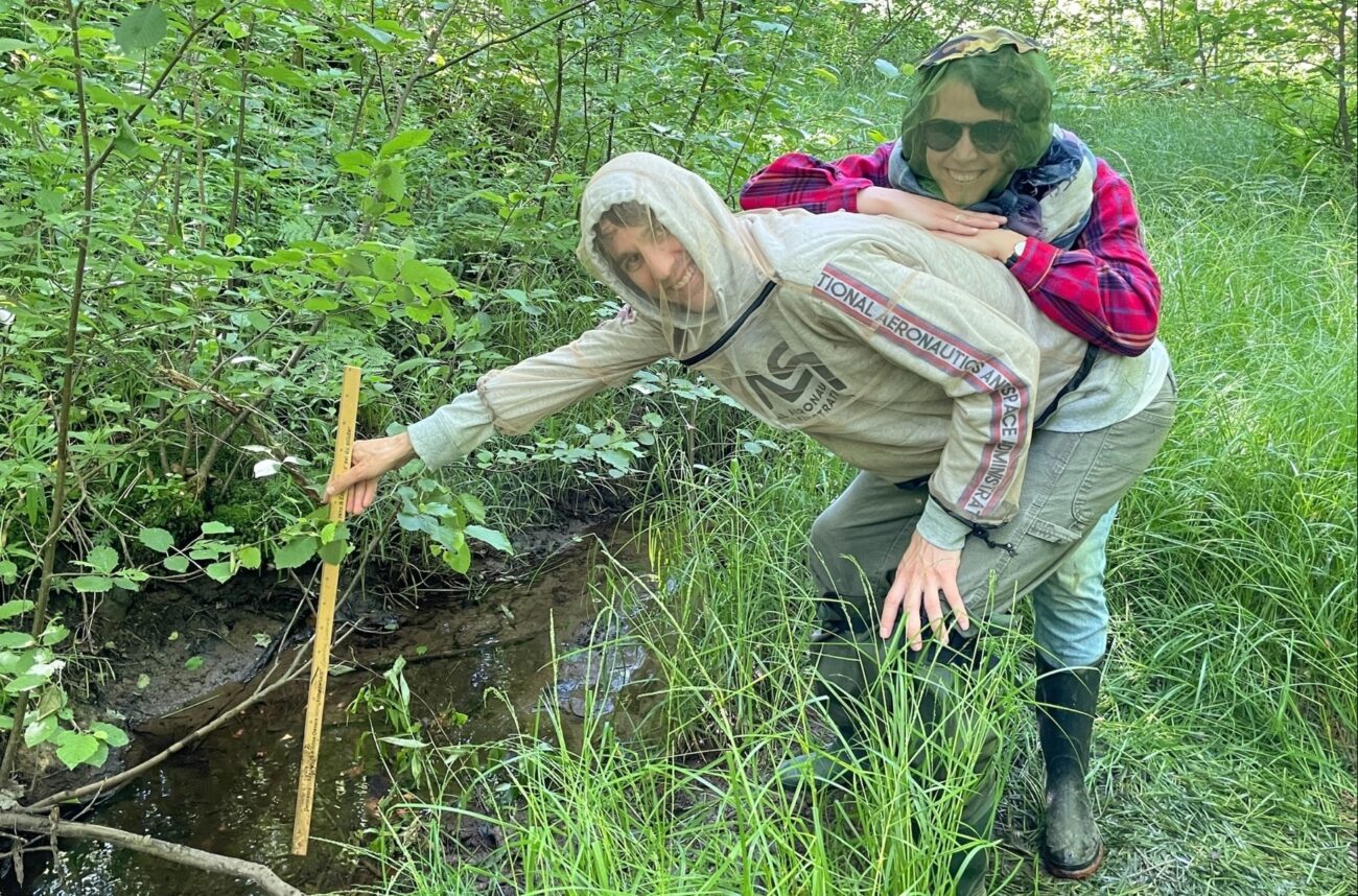 2 volunteers measure stream depth at Taylor NR on Black River